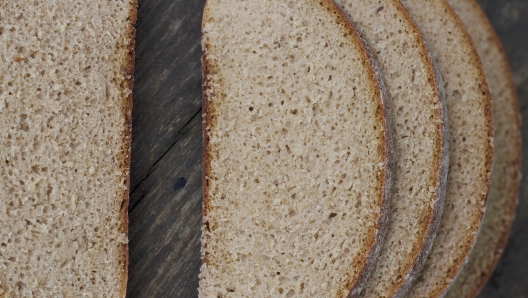 close up of fresh sliced brown bread on the table