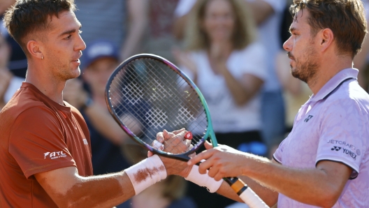 Australia's Thanasi Kokkinakis, left, and Switzerland's Stan Wawrinka shake hands after their second round match of the French Open tennis tournament at the Roland Garros stadium in Paris, Wednesday, May 31, 2023. (AP Photo/Jean-Francois Badias)