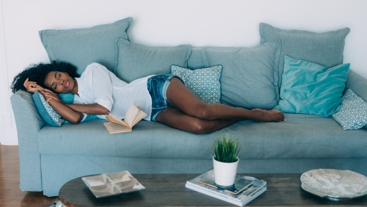 Beautiful black young woman sleeping in the sofa