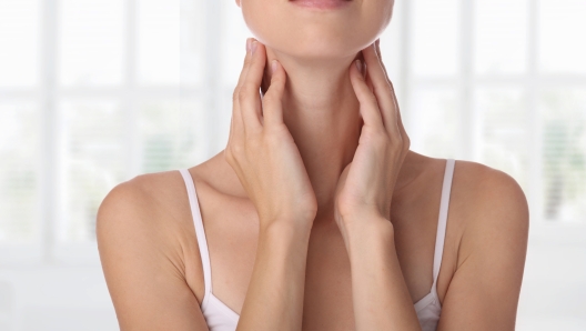 Close up of female neck and shoulders. Woman thyroid gland control.