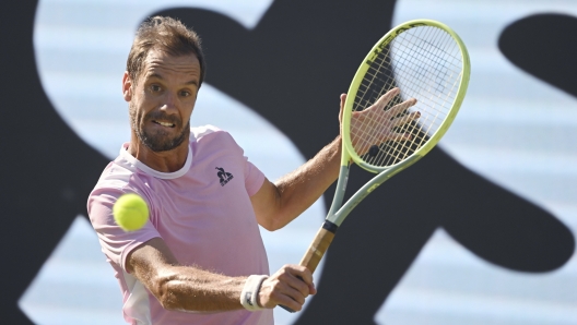 France's Richard Gasquet returns the ball to Greece's Stefanos Tsitsipas during their round of sixteen tennis match at the ATP tennis tournament in Stuttgart, Germany, Thursday, June 15, 2023. (Marijan Murat/dpa via AP)