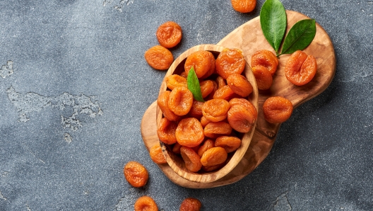 Dried apricots on gray background. witn copy space. Top view.