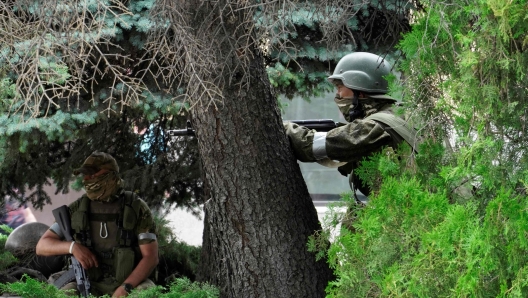 TOPSHOT - Members of Wagner group stand guard in a street in the city of Rostov-on-Don, on June 24, 2023. President Vladimir Putin on June 24, 2023 said an armed mutiny by Wagner mercenaries was a "stab in the back" and that the group's chief Yevgeny Prigozhin had betrayed Russia, as he vowed to punish the dissidents. Prigozhin said his fighters control key military sites in the southern city of Rostov-on-Don. (Photo by STRINGER / AFP)