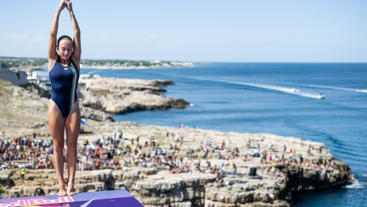 Elisa Cosetti of Italy prepares to dive from the 22 metre platform during the second competition day of the seventh stop of the Red Bull Cliff Diving World Series at Polignano a Mare, Italy on September 17, 2022. // Romina Amato / Red Bull Content Pool // SI202209170362 // Usage for editorial use only //