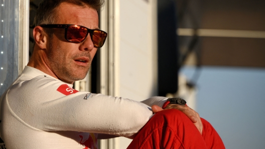 French driver Sebastien Loeb looks on the end of the Stage 8 of the Dakar Rally 2022 between al-Dawadimi and Wadi Ad-Dawasir in Saudi Arabia, on January 10, 2022. - France's nine-time world rally champion Sebastien Loeb made inroads into overall Dakar leader Nasser al-Attiyah's advantage after finishing third in Monday's 395 kilometres special stage from al-Dawadimi to Wadi Ad Dawasir. (Photo by FRANCK FIFE / AFP)