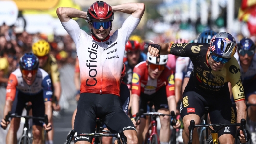 Jumbo-Visma's Belgian rider Wout Van Aert (R) reacts as Cofidis' French rider Victor Lafay (L) celebrates after winning the 2nd stage of the 110th edition of the Tour de France cycling race 208,9 km between Vitoria-Gasteiz and San Sebastian, in northern Spain, on July 2, 2023. (Photo by Anne-Christine POUJOULAT / AFP)