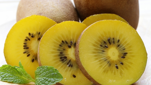 ripe yellow kiwi on a wooden board