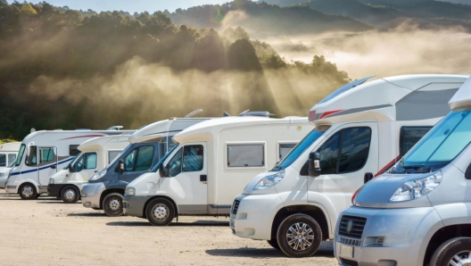 Close up motorhomes parked in a row with fog in the morning background, Chiang Mai Province, Thailand