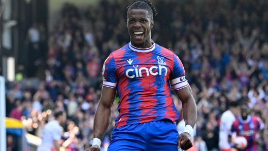 Crystal Palace's Ivorian striker Wilfried Zaha celebrates after scoring their second goal during the English Premier League football match between Crystal Palace and West Ham United at Selhurst Park in south London on April 29, 2023. (Photo by JUSTIN TALLIS / AFP) / RESTRICTED TO EDITORIAL USE. No use with unauthorized audio, video, data, fixture lists, club/league logos or 'live' services. Online in-match use limited to 120 images. An additional 40 images may be used in extra time. No video emulation. Social media in-match use limited to 120 images. An additional 40 images may be used in extra time. No use in betting publications, games or single club/league/player publications. /