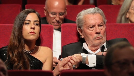 (FILES) French actor Alain Delon (R) holds the hand of his daughter French actress Anouchka Delon before being awarded with an Honorary Palme d'Or at the 72nd edition of the Cannes Film Festival in Cannes, southern France, on May 19, 2019. Alain Delon's children filed a complaint on July 5, 2023, against the actor's companion for moral harassment and misappropriation of correspondence, their lawyer told AFP. (Photo by Valery HACHE / AFP)