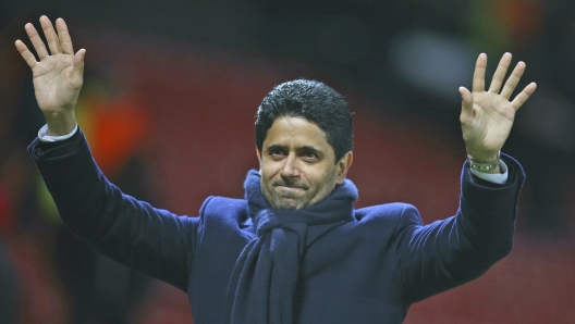 FILE - Paris Saint Germain owner Nasser bin Ghanim Al-Khelaifi waves to his team fans after the end of the Champions League round of 16 soccer match between Manchester United and Paris Saint Germain at Old Trafford stadium in Manchester, England, Feb. 12, 2019. Speaking in Istanbul ahead of the Champions League final on Saturday June 10, 2023, Paris Saint-Germain president Nasser Al-Khelaifi says he is not part of a potential Qatari-based bid to buy Manchester United. (AP Photo/Dave Thompson, File)