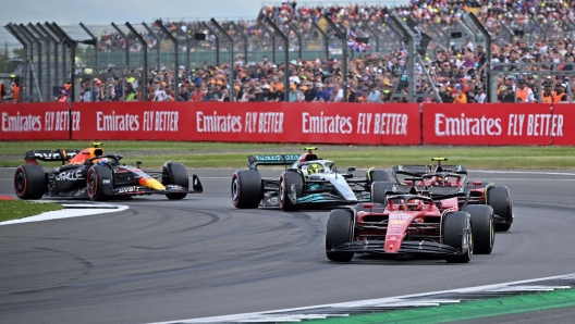 Ferrari's Monegasque driver Charles Leclerc leads Ferrari's Spanish driver Carlos Sainz Jr, Mercedes' British driver Lewis Hamilton and Red Bull Racing's Mexican driver Sergio Perez following a restart by safety car during the Formula One British Grand Prix at the Silverstone motor racing circuit in Silverstone, central England on July 3, 2022. (Photo by JUSTIN TALLIS / AFP)