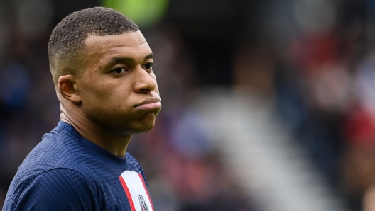 (FILES) Paris Saint-Germain's French forward Kylian Mbappe reacts during the French L1 football match between Paris Saint-Germain (PSG) and FC Lorient at The Parc des Princes Stadium in Paris on April 30, 2023. Paris Saint-Germain president Nasser al-Khelaifi on July 5, 2023 insisted superstar forward Kylian Mbappe "must sign a new contract" if he wants to remain at the club next season. (Photo by FRANCK FIFE / AFP)