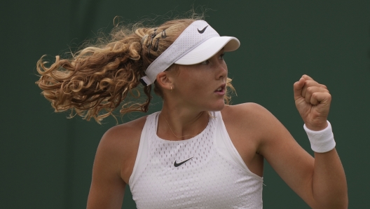 Russia's Mirra Andreeva celebrates winning.a point from Russia's Anastasia Potapova during the women's singles match on day seven of the Wimbledon tennis championships in London, Sunday, July 9, 2023. (AP Photo/Alberto Pezzali)