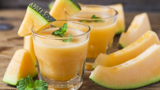 The juice of melon with mint in a glass jar on the table.Hami melon