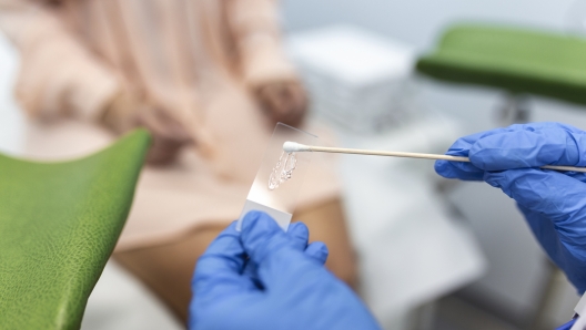 Vaginal Smear. Close-up of doctor hand holds gynecological examination instruments. Gynecologist working in the obstetrics and gynecology clinic.