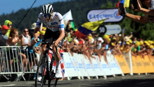 epa10746367 Slovenian rider Tadej Pogacar of team UAE Team Emirates arrives at the finish at 3rd place during the 13th stage of the Tour de France 2023, a 138kms race from Chatillon-Sur-Charlaronne to Grand Colombier, France, 14 July 2023.  EPA/MARTIN DIVISEK