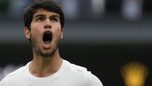 Spain's Carlos Alcaraz reacts after winning a point against Russia's Daniil Medvedev in a men's singles semifinal match on day twelve of the Wimbledon tennis championships in London, Friday, July 14, 2023. (AP Photo/Alastair Grant)