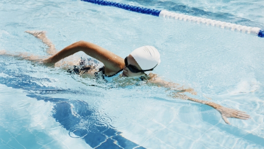 Young Woman Swimming in a Pool