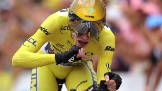 Jumbo-Visma's Danish rider Jonas Vingegaard wearing the overall leader's yellow jersey cycles to the finish line during the 16th stage of the 110th edition of the Tour de France cycling race, 22 km individual time trial between Passy and Combloux, in the French Alps, on July 18, 2023. (Photo by Thomas SAMSON / AFP)