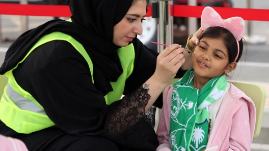 Female Saudi supporters of Al-Ahli arrive at the King Abdullah Sports City in Jeddah on January 12, 2018, ahead of their teams football match against Al-Batin in the Saudi Pro League. Saudi Arabia will allow women to enter a football stadium for the first time to watch a match, as the ultra-conservative kingdom eases strict decades-old rules separating the sexes. (Photo by STRINGER / AFP)