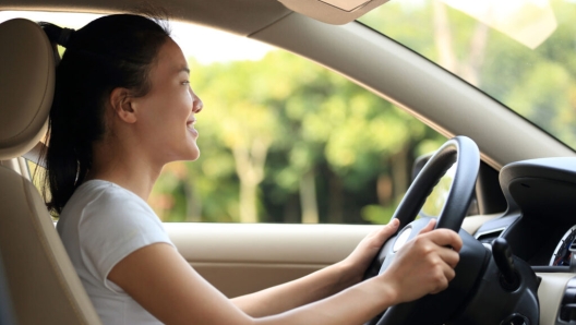 young asian woman driver driving a car