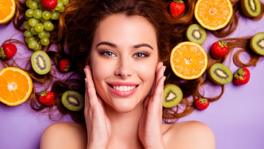 Close-up cropped portrait of nice attractive lovely well-groomed pure perfect, shine cheerful cheery feminine wavy-haired lady touching smooth clean clear skin isolated over violet purple background