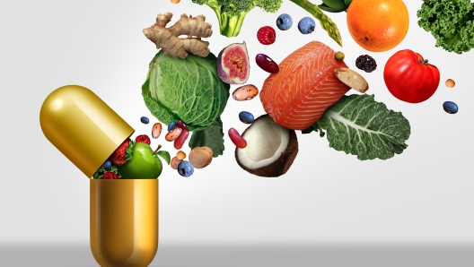 Vitamins supplements as a capsule with fruit vegetables nuts and beans inside a nutrient pill as a natural medicine health treatment with 3D illustration elements.