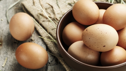 Brown eggs in a plate. Rural scene