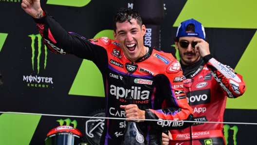 Race winner, Aprilia Racing Spanish rider Aleix Espargaro celebrates on the podium at the presentation after the Moto GP race of the motorcycling British Grand Prix at Silverstone circuit in Northamptonshire, central England, on August 6, 2023. (Photo by Ben Stansall / AFP)