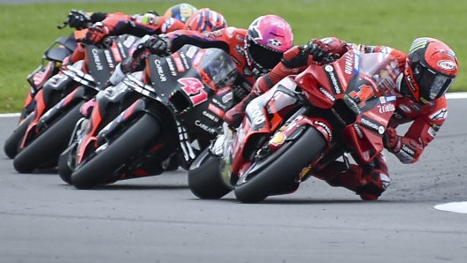 Italian rider Francesco Bagnaia of the Ducati Lenovo Team, right, steers his motorcycle followed by Spain's rider Aleix Espargaro of the Aprilia Racing during the MotoGP race of the British Motorcycle Grand Prix at the Silverstone racetrack, in Silverstone, England, Sunday, Aug. 6, 2023. (AP Photo/Rui Vieira)