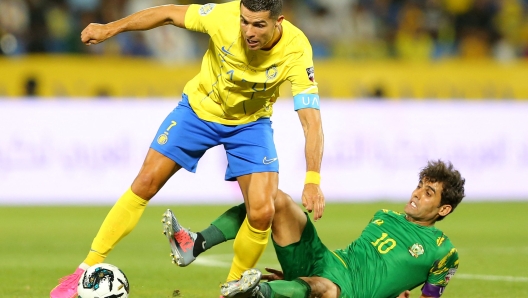 Nassr's Portuguese forward Cristiano Ronaldo (L) vies for the ball with Shorta's forward Alaa al-Azzawi during the 2023 Arab Club Champions Cup semi-final football match between Saudi Arabia's Al-Nassr and Iraq's Al-Shorta at Prince Sultan bin Abdul Aziz Stadium in Abha on August 9, 2023. (Photo by Abdullah Mahdi / AFP)