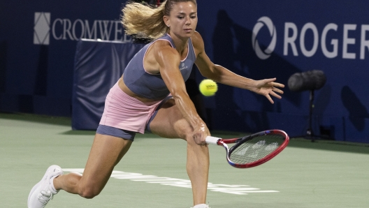 Camila Giorgi, of Italy, hits a return to Petra Kvitova, of the Czech Republic, during the National Bank Open women?s tennis tournament Wednesday, Aug. 9, 2023, in Montreal. (Christinne Muschi/The Canadian Press via AP)