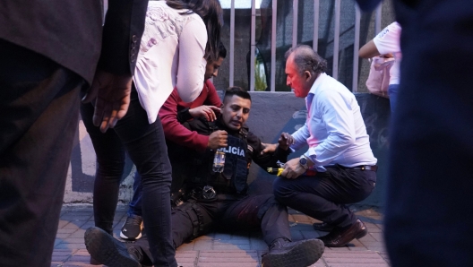 A policeman is assisted after being wounded after shots were fired at the end of a rally of Ecuadorian presidential cadidate Fernando Villavicencio in Quito, on August 9, 2023. Ecuadorian presidential candidate Fernando Villavicencio was shot dead after holding a rally in Quito on Wednesday evening, local media reported, citing Interior Minister Juan Zapata. Mr. Villavicencio, a 59-year-old journalist, was one of eight candidates in the August 20 presidential election. (Photo by AFP)