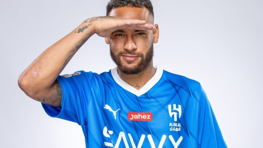 In this handout picture released by the Saudi Al-Hilal football club on August 15, 2023, Brazilian forward Neymar poses for a picture in the team's uniform in Riyadh. Brazil forward Neymar has signed for Saudi Arabia's Al-Hilal from Paris Saint-Germain, the clubs announced today, joining Cristiano Ronaldo and Karim Benzema as the latest big name lured to the oil-rich Gulf state. (Photo by Saudi Pro League / AFP)