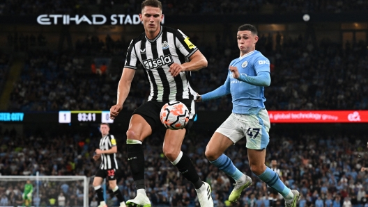 Manchester City's English midfielder #47 Phil Foden challenges Newcastle United's Dutch defender #04 Sven Botman during the English Premier League football match between Manchester City and Newcastle United at the Etihad Stadium in Manchester, north west England, on August 19, 2023. (Photo by Paul ELLIS / AFP) / RESTRICTED TO EDITORIAL USE. No use with unauthorized audio, video, data, fixture lists, club/league logos or 'live' services. Online in-match use limited to 120 images. An additional 40 images may be used in extra time. No video emulation. Social media in-match use limited to 120 images. An additional 40 images may be used in extra time. No use in betting publications, games or single club/league/player publications. /