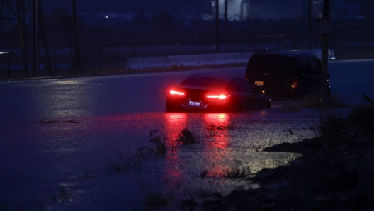 epa10811188 A car is half submerged in water on the side of a road in Santa Clarita, California, USA, 20 August 2023. Southern California is under a tropical storm warning for the first time in history as Hilary makes landfall. The last time a tropical storm made landfall in Southern California was 15 September 1939, according to the National Weather Service.  EPA/CAROLINE BREHMAN