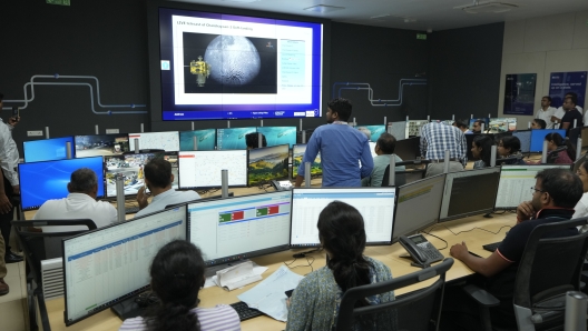 People watch the live telecast of the landing of Chandrayaan-3, at the Integrated Command Control Centre (ICCC) in Varanasi, India, Wednesday, Aug. 23, 2023. India has landed a spacecraft near the moon's south pole, an unchartered territory that scientists believe could hold vital reserves of frozen water and precious elements, as the country cements its growing prowess in space and technology. (AP Photo/Rajesh Kumar Singh)