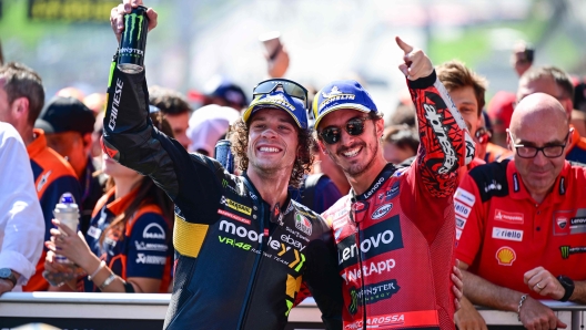 Ducati Lenovo Team Italian rider Francesco Bagnaia (C-R) and Mooney VR46 Racing Team Italian rider Marco Bezzecchi (C-L) celebrate their first and third places respectively after winning the MotoGP Austrian Grand Prix at the Red Bull Ring racetrack in Spielberg bei Knittelfeld, Austria, on August 20, 2023. (Photo by Jure Makovec / AFP)