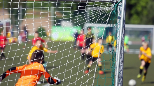 Young boys play football match