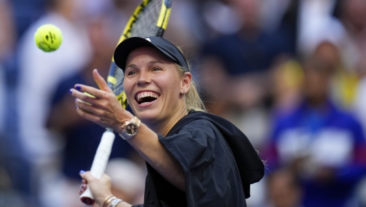 Caroline Wozniacki, of Denmark, hits balls to fans after defeating Jennifer Brady, of the United States, during the third round of the U.S. Open tennis championships, Friday, Sept. 1, 2023, in New York. (AP Photo/Manu Fernandez)