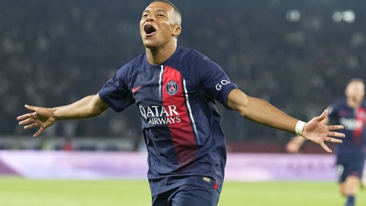 PSG's Kylian Mbappe celebrates his team's third goal during the French League One soccer match between Paris Saint-Germain and Lens at the Parc des Princes stadium in Paris, Saturday, Aug. 26, 2023. (AP Photo/Michel Euler)