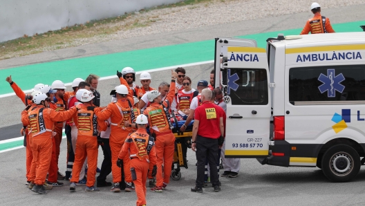 Ducati Italian rider Francesco Bagnaia is taken into an ambulance on a stretcher after a fall during the MotoGP race of the Moto Grand Prix de Catalunya at the Circuit de Catalunya in Montmelo, on the outskirts of Barcelona, on September 3, 2023. (Photo by LLUIS GENE / AFP)