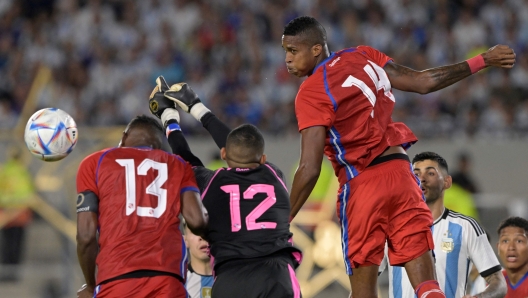 Panama's defenders Jiovany Ramos (L) and Gilberto Hernandez (R) jump for the ball with goalkeeper Jose Guerra to clear the ball from the goal during the friendly football match between Argentina and Panama at the Monumental stadium in Buenos Aires on March 23, 2023. Hernandez was shot dead by unknown gunmen in the Panamanian Caribbean city of Colon on September 3, 2023, and a suspect was arrested, police informed on September 4. The 26-year-old defender died Sunday afternoon when he and six other people were gunned down by unknown assailants in a car in a city where crime rates have risen due to apparent disputes between drug gangs. (Photo by Juan MABROMATA / AFP)