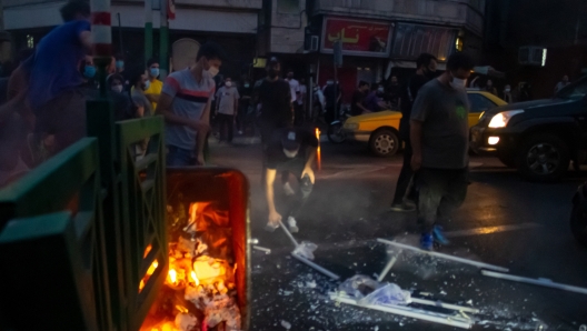 09/21/2022 Tehran, Iran. People gather during a protest.The nationwide protests started after the death of Mahsa Amini, a 22-year-old girl who died under the custody of the Islamic Republic's Morality Police on September 16th, 2022 in Tehran. (Photo by Anonymous / Middle East Images / Middle East Images via AFP)