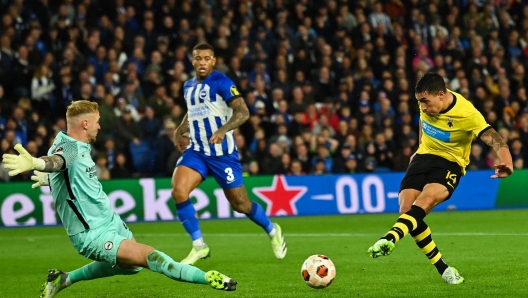 AEK's Argentinian forward #14 Ezequiel Ponce shoots and scores his team third goal during the UEFA Europa League Group B football match between Brighton and Hove Albion and AEK Athens at the American Express Community Stadium in Brighton, southern England on September 21, 2023. (Photo by Glyn KIRK / AFP)