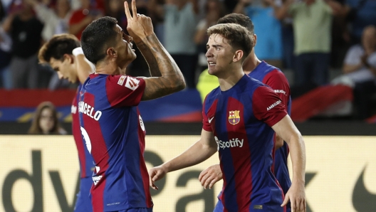 epa10879425 FC Barcelona's defender Joao Cancelo (L) celebrates with teammate Gavi (R) after scoring the 3-2 goal during the Spanish LaLiga soccer match between FC Barcelona and RC Celta Vigo, in Barcelona, Spain, 23 September 2023.  EPA/Toni Albir