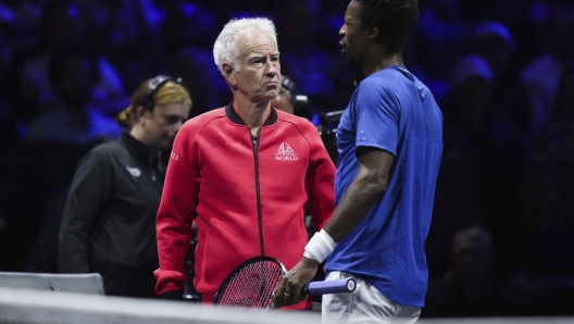 Team Europe's Gael Monfils, right, speaks to team captain John McEnroe during a changeover in a Laver Cup match against Team World's Felix Auger-Aliassime on Friday, Sept. 22, 2023, in Vancouver, British Columbia. (Darryl Dyck/The Canadian Press via AP)