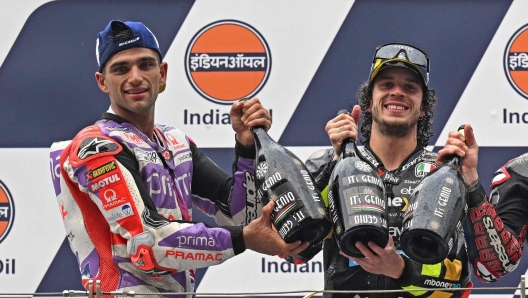 First placed Mooney VR46 Racing Team's Italian rider Marco Bezzecchi (C), second placed Prima Pramac Racing's Spanish rider Jorge Martin (L) and third placed Monster Energy Yamaha's French rider Fabio Quartararo pose on the podium after the Indian MotoGP Grand Prix at the Buddh International Circuit in Greater Noida on the outskirts of New Delhi, on September 24, 2023. (Photo by Money SHARMA / AFP)