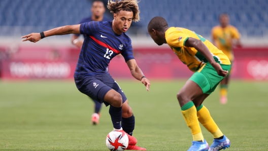 SAITAMA, JAPAN - JULY 25: Alexis Beka Beka #12 of Team France battles for possession with Teboho Mokoena #4 of Team South Africa during the Men's First Round Group A match between France and South Africa on day two of the Tokyo 2020 Olympic Games at Saitama Stadium on July 25, 2021 in Saitama, Japan. (Photo by Naomi Baker/Getty Images)